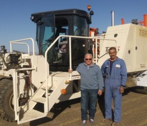 owners of Dixon Turf stand by new harvester